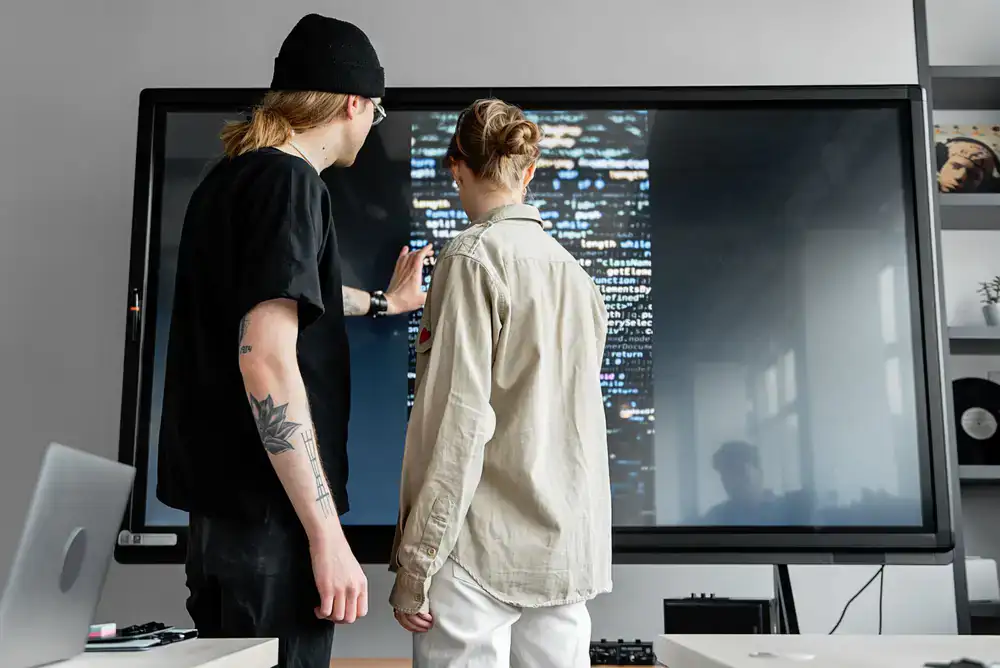 Developers working together on a bright, cozy game interface